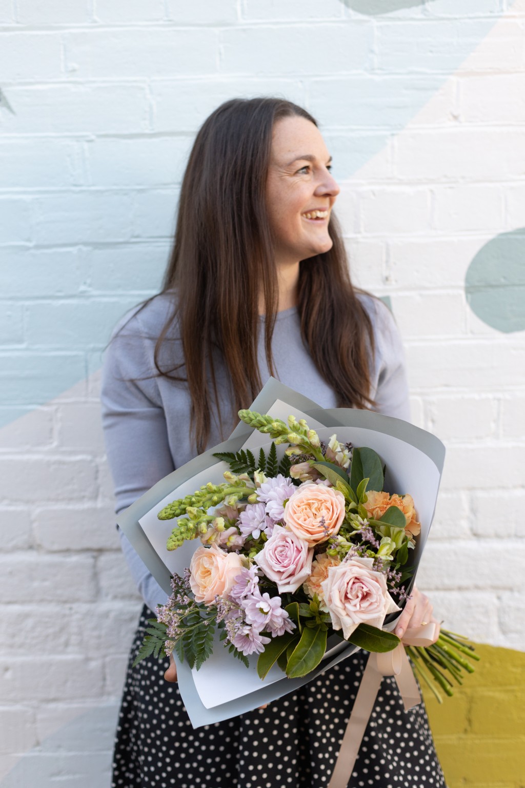 Florist holding a large bouquet of beautiful flowers to be delivered in Wagga Wagga