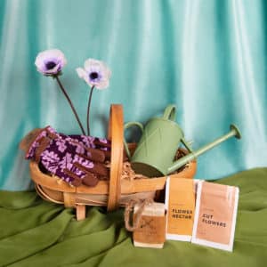 Gardening gloves, indoor watering can, soap and seeds in a trug from our hamper, available to add to a fresh flower delivery from our wagga Wagga florist shop.